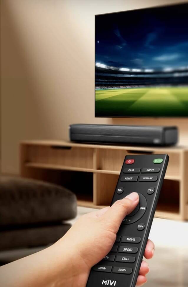 Mivi soundbar placed on a TV stand with a remote control beside it